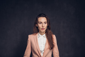 Worried adult caucasian woman on dark background