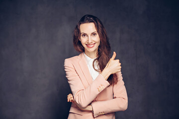 caucasian woman show thumb up on dark background