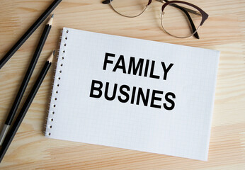 FAMILY BUSINESS written on a white tablet that is held by a man. Business concept