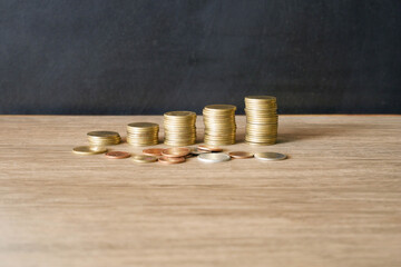 stacks of gold coins concept save money