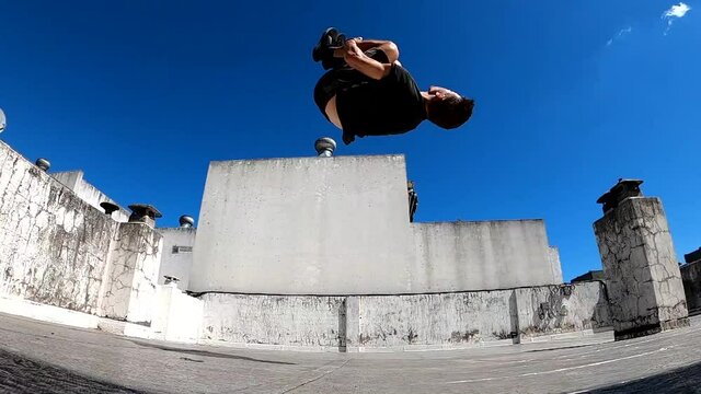 man jumping backflip on the street in slow motion 