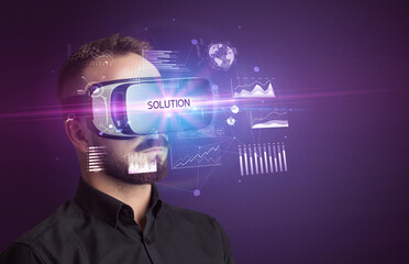 Businessman looking through Virtual Reality glasses with SOLUTION inscription, new business concept