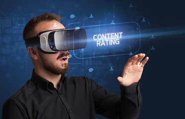 Businessman looking through Virtual Reality glasses with CONTENT RATING inscription, social networking concept