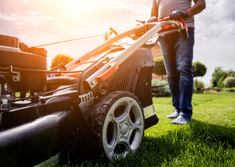 Gardener mowing the lawn. Landscape design. Green background