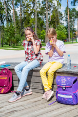 School children having lunch together outside the building.