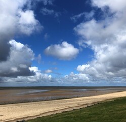 The Wadden Sea National Park, North Sea, Esbjerg, Denmark. Dyke, beach and marshland at low tide.