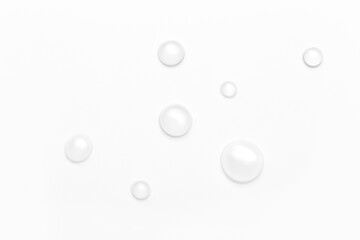 drops of water on a white background, top view