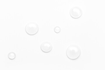 drops of water on a white background, top view