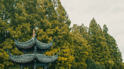 Traditional Chinese pavilion in front of trees in Hangzhou, China