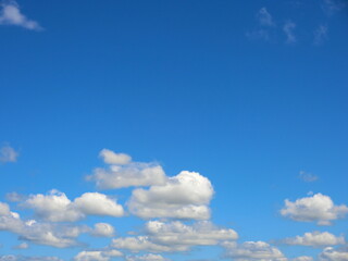 Naklejka premium Blue brigt beautiful and clean sky in sunny day with group of soft white clouds with copy space on top.