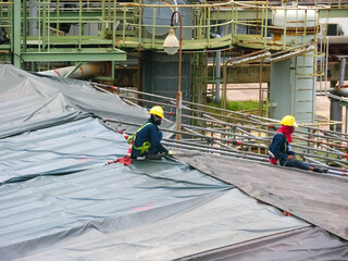 Naklejka premium Contractors work and are using tools in industrial plants