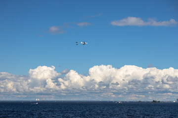 planes are flying against the background of blue sky with clouds
