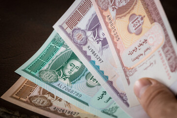 Mongolian currency, Tugrik money, Various banknotes held in the hand