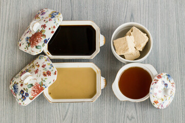 Traditional Turkish Halva,honey and molasses group on wooden table.Top view