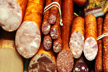 Sausage of different types on the counter in the store. Trade in meat products of good quality. Close-up