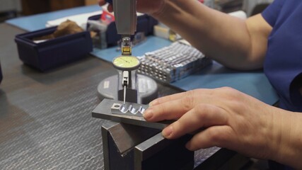 Worker hands mounts drill on the factory