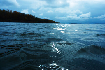 Small waves on the river during cloudy weather. Beautiful pre-storm landscape. Toned photo