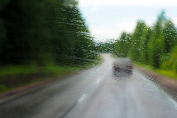 Windshield. Road through the wet windshield of the car in the rain