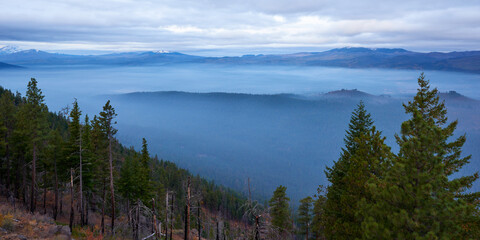 Fog in the mountain valley in the morning. Panoramic view from Green Ridge Lookout in Central Oregon.