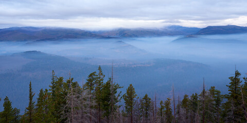 Foggy mountain valley in the morning. Panoramic view from Green Ridge Lookout in Central Oregon.
