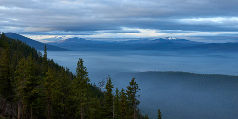 Fototapeta na wymiar Foggy mountains in the morning. Panoramic view from Green Ridge Lookout in Central Oregon.