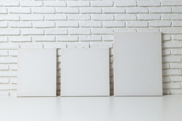 Mock up Empty white canvas frame on table