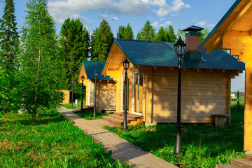Wooden houses located on the lake shore are used for outdoor picnics with family or friends.