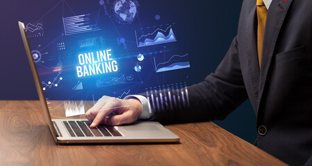 Businessman working on laptop with ONLINE BANKING inscription, new business concept