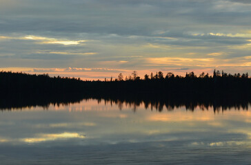 Finnish summer night. Lake and sunset. Fading light, pastel colors. Serene and beautiful nature.