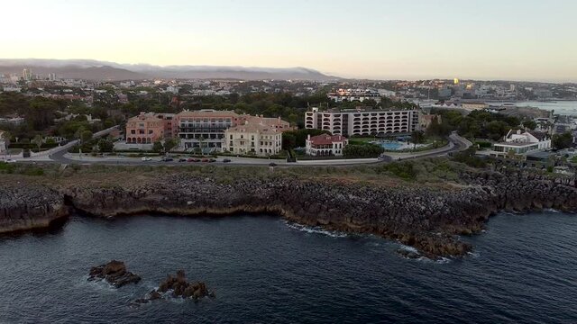 Amazing aerial view at sunset of the little village of Cascais not far from Lisbon in Portugal. The landscape of the city near to the Ocean.  The shoreline to the west has cliffs, attracting tourists.