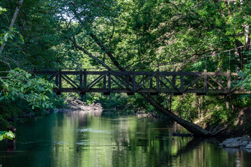 Fototapeta na wymiar Medieval old ancient stone wooden bridge crossing over the Flint river on a summer morning