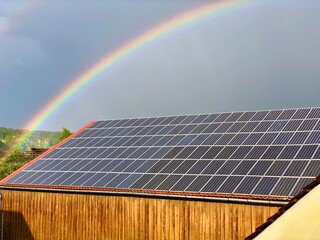 Rainbow over a solar roof in Bavaria, Germany.