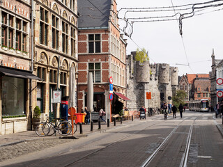 street life in ghent with cafés and train