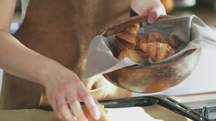 Close up of cooked croissants in wooden bowl