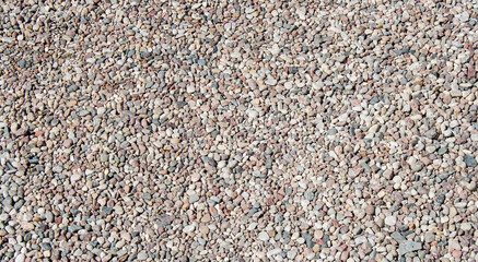 Gravel texture Small stones, little rocks, pebbles in many shades of grey, white, brown, pink colour. Crushed granite texture. Road made of stones. Small rock background. Banner for web site