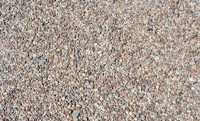 Gravel texture. Small stones, little rocks, pebbles in many shades of grey, white, brown, pink colour. Crushed granite texture. Road made of stones. Small rock background. Banner for web site