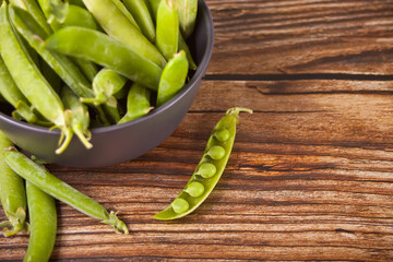 Organic fresh green peas and pea pods.
