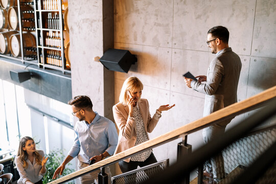 Busy Business People On Stairs In Modern Office