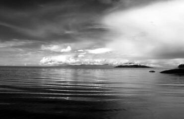 Black & white ocean and lake scenes with dynamic active cloudy skies and water reflections