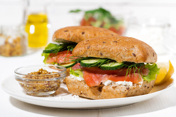 sandwich with salted fish, vegetebles and cream cheese on the white plate