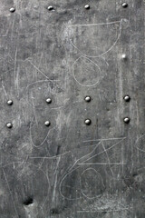 Gray and silver metal sheet with scratches and screws for background texture