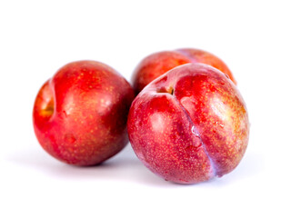Red plums isolated on the white background