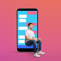 Cheerful boy sitting on smart phone screen with sms bubbles