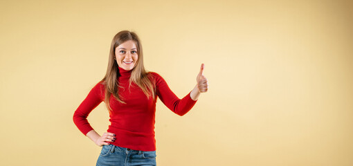 Good looking blonde female with pure healthy skin looks in amazement as indicates at something...