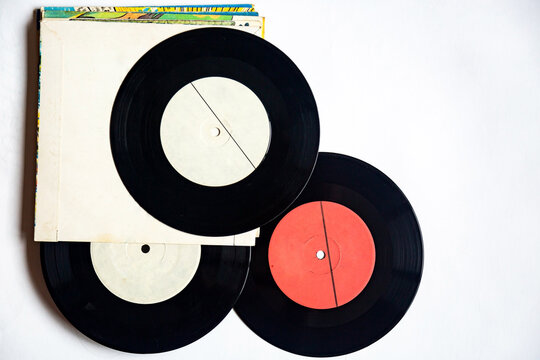 Vinyl records of different diameters on a white background