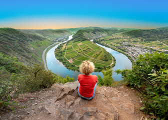 woman looking at moselle river loop at village of bremm