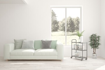 White living room with sofa and summer landscape in window. Scandinavian interior design. 3D illustration