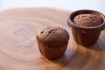 Homemade chocolate cupcakes on a wooden table. Close-up. With copy space.