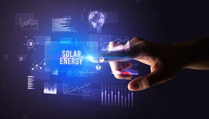 Hand touching SOLAR ENERGY inscription, new business technology concept