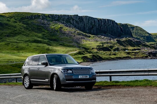 The legendary Range Rover L405 Type SUV parked in a beautiful nature near Duntulm Castle in Scotland